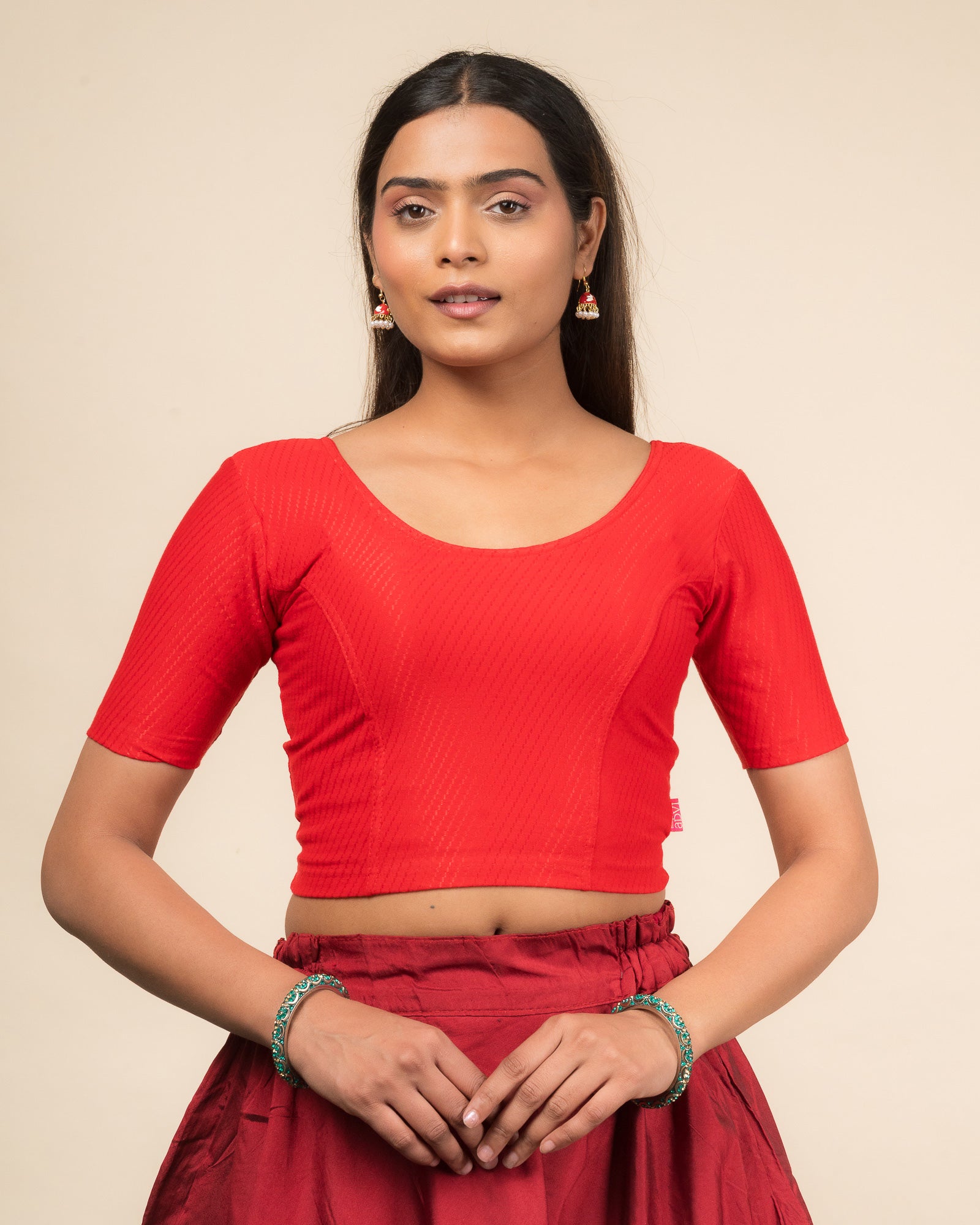 Model wearing a dobby cotton stretchable blouse with elbow sleeves and round neckline
