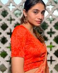 Ambreen Orange Frill Jacquard Blouse with Fancy Back Cut by Advi