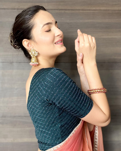Model pairing the blouse with a saree for a bold, festive look.