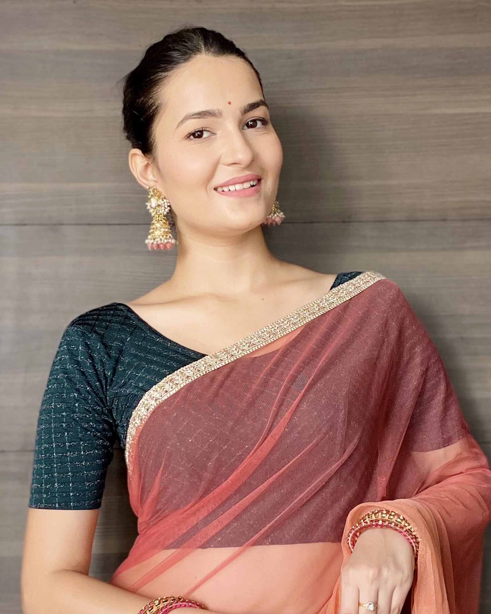 Model pairing the blouse with a saree for a bold, festive look.