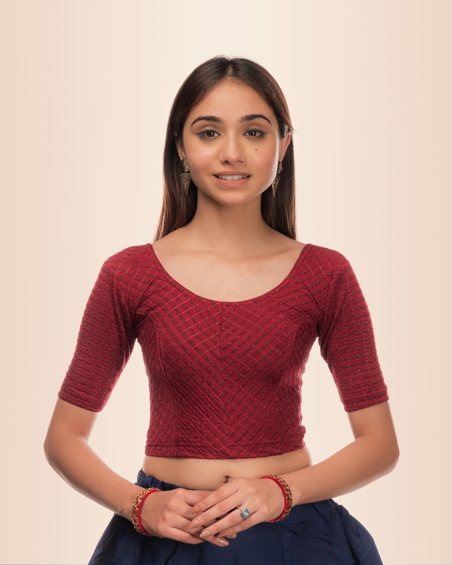 Model wearing a stretchable blouse with metallic zig‑zag stripes, elbow sleeves, and round neckline