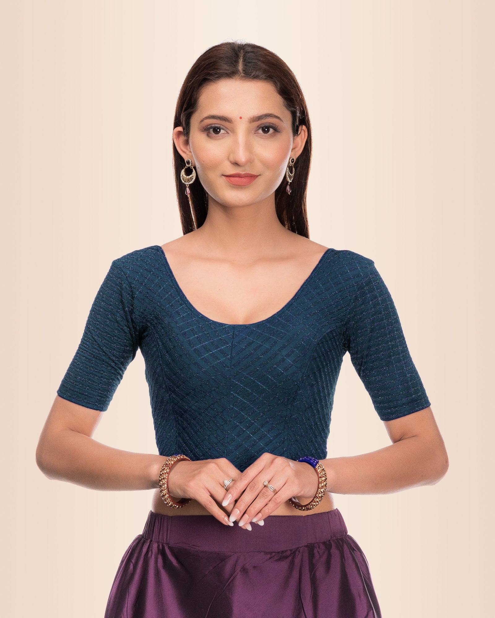 Model wearing a stretchable blouse with metallic zig‑zag stripes, elbow sleeves, and round neckline