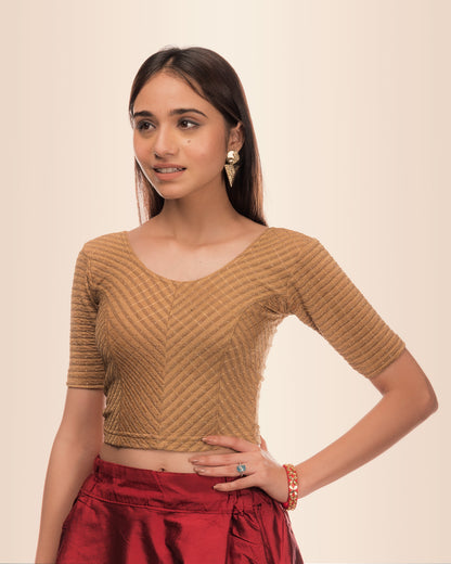 Model wearing a stretchable blouse with metallic zig‑zag stripes, elbow sleeves, and round neckline