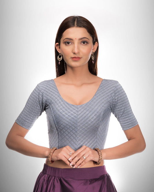 Model wearing a stretchable blouse with metallic zig‑zag stripes, elbow sleeves, and round neckline