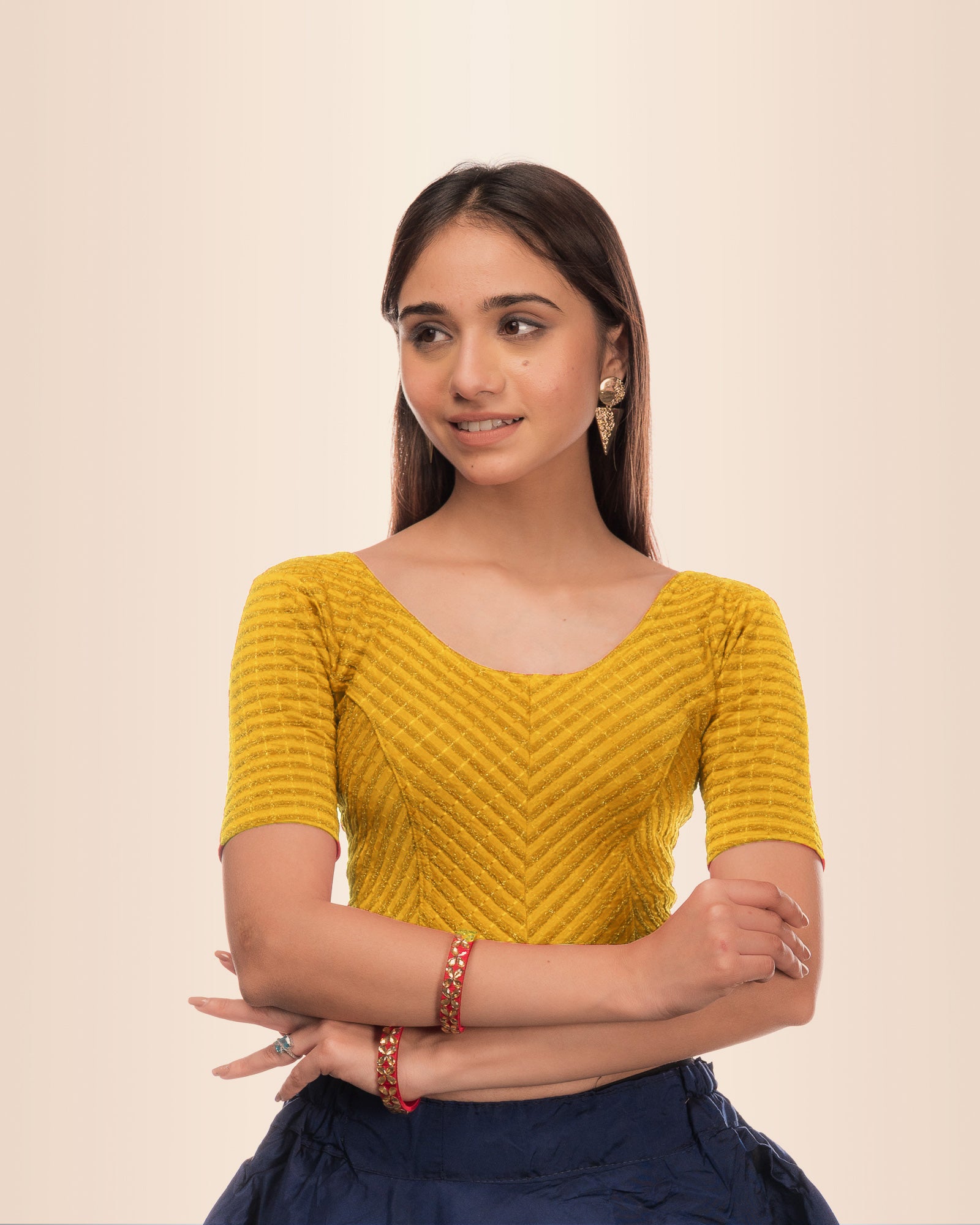 Model wearing a stretchable blouse with metallic zig‑zag stripes, elbow sleeves, and round neckline