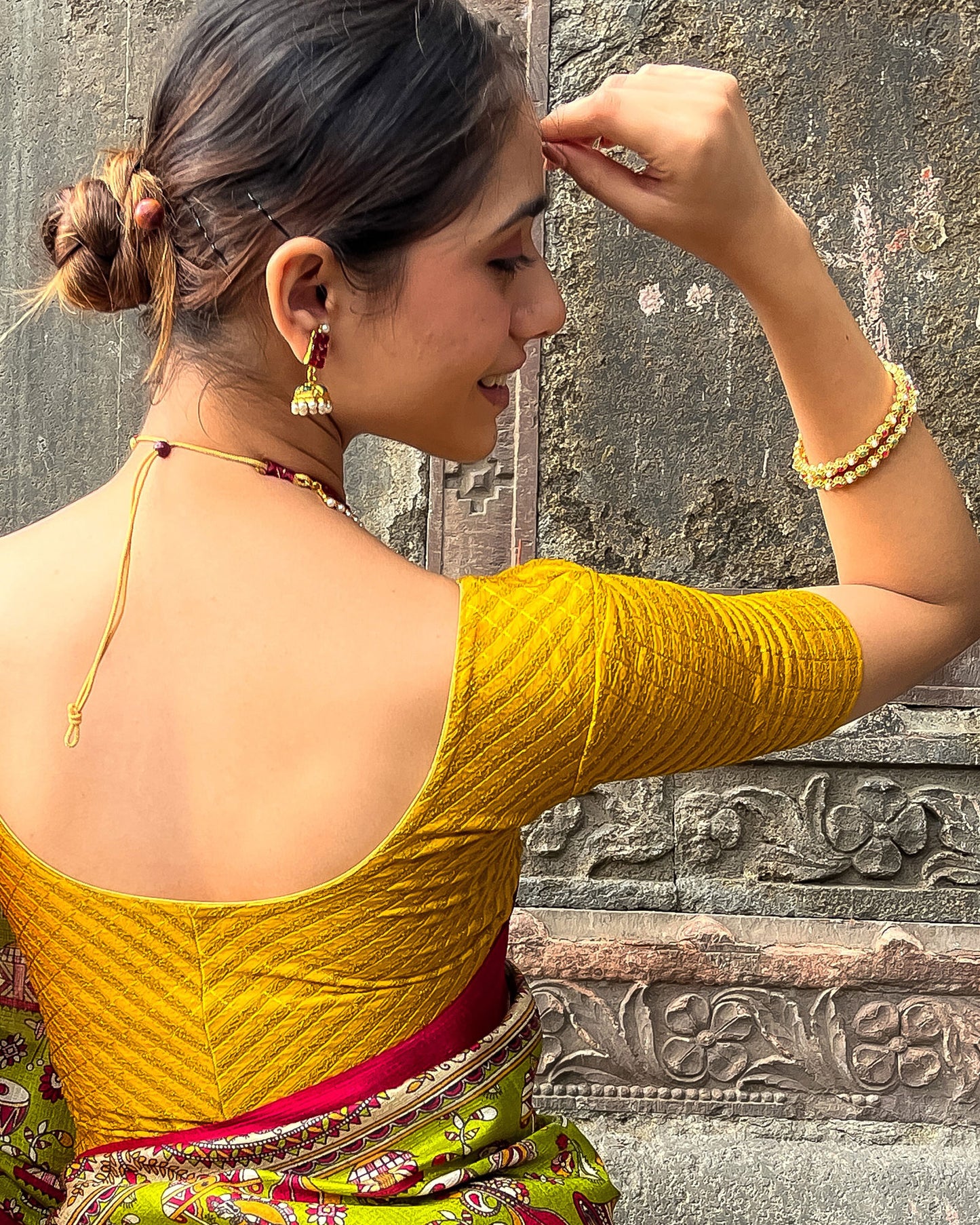 Model pairing the blouse with a saree for a bold, festive look
