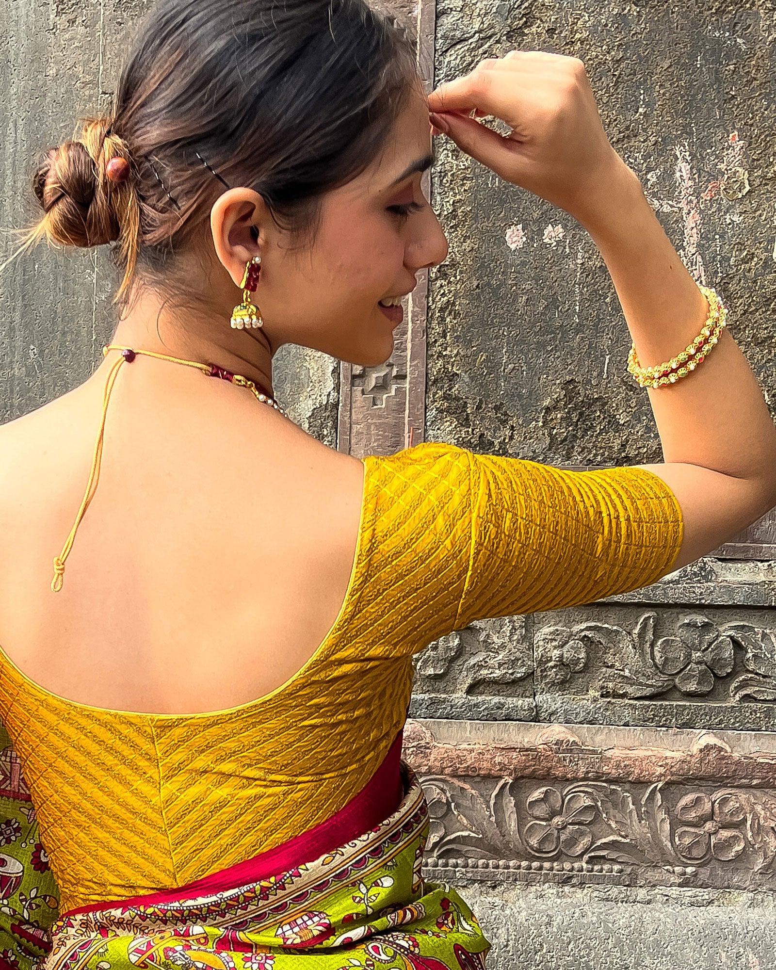 Model pairing the blouse with a saree for a bold, festive look