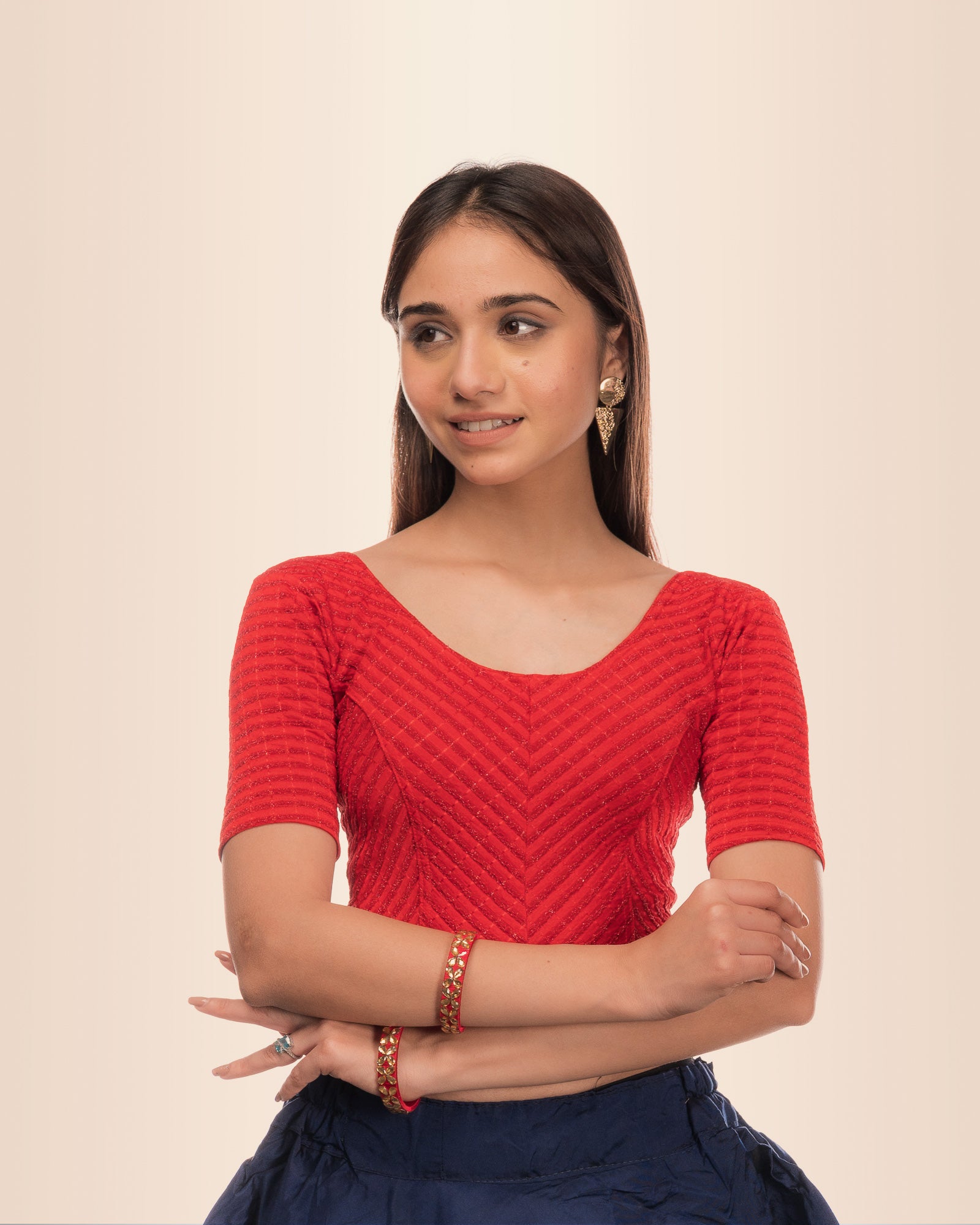 Model wearing a stretchable blouse with metallic zig‑zag stripes, elbow sleeves, and round neckline