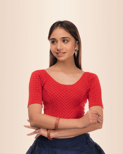 Model wearing a stretchable blouse with metallic zig‑zag stripes, elbow sleeves, and round neckline