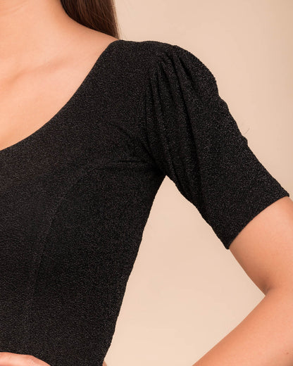 Close-up of the lurex fabric with fine pleating and subtle sheen