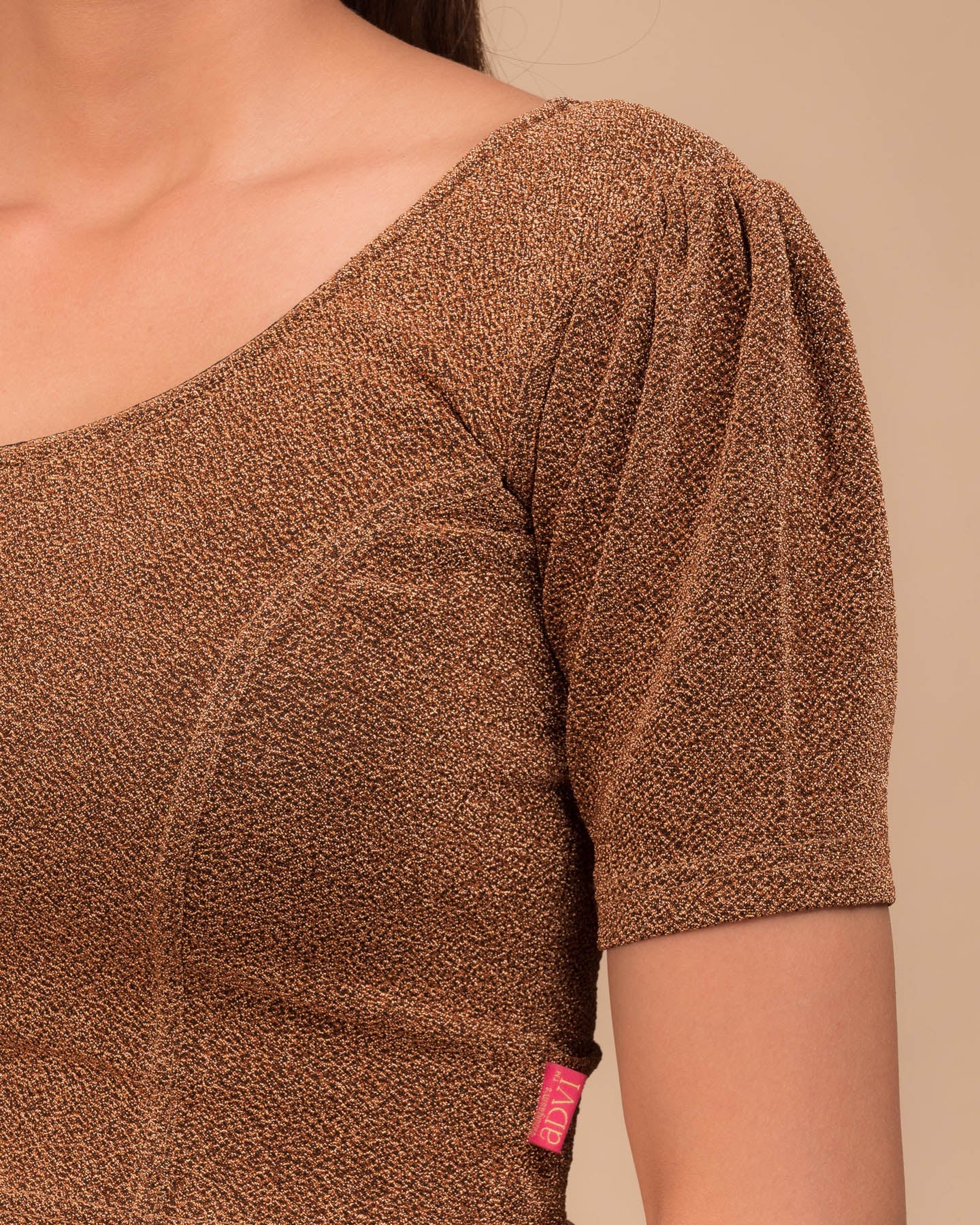 Close-up of the lurex fabric with fine pleating and subtle sheen