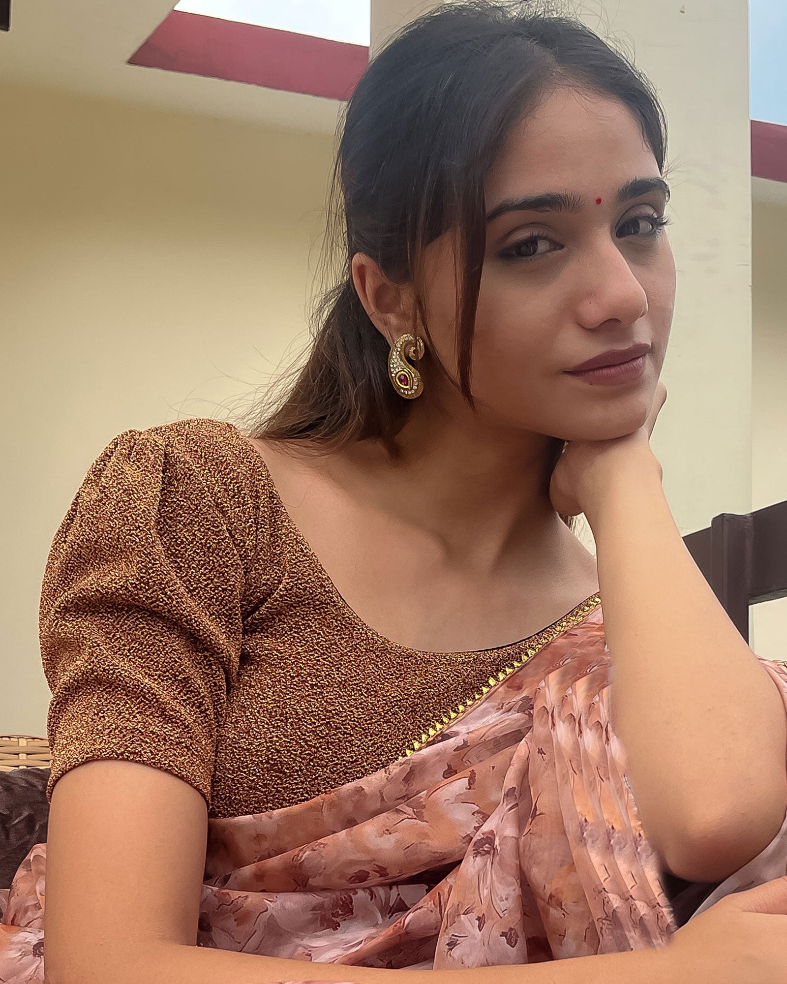 Model pairing the blouse with a saree for a polished festive ensemble