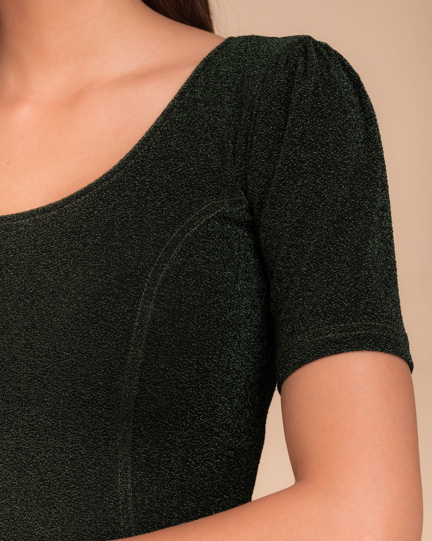 Close-up of the lurex fabric with fine pleating and subtle sheen