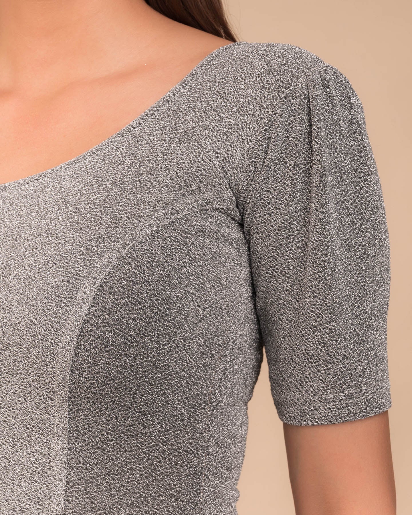 Close-up of the lurex fabric with fine pleating and subtle sheen