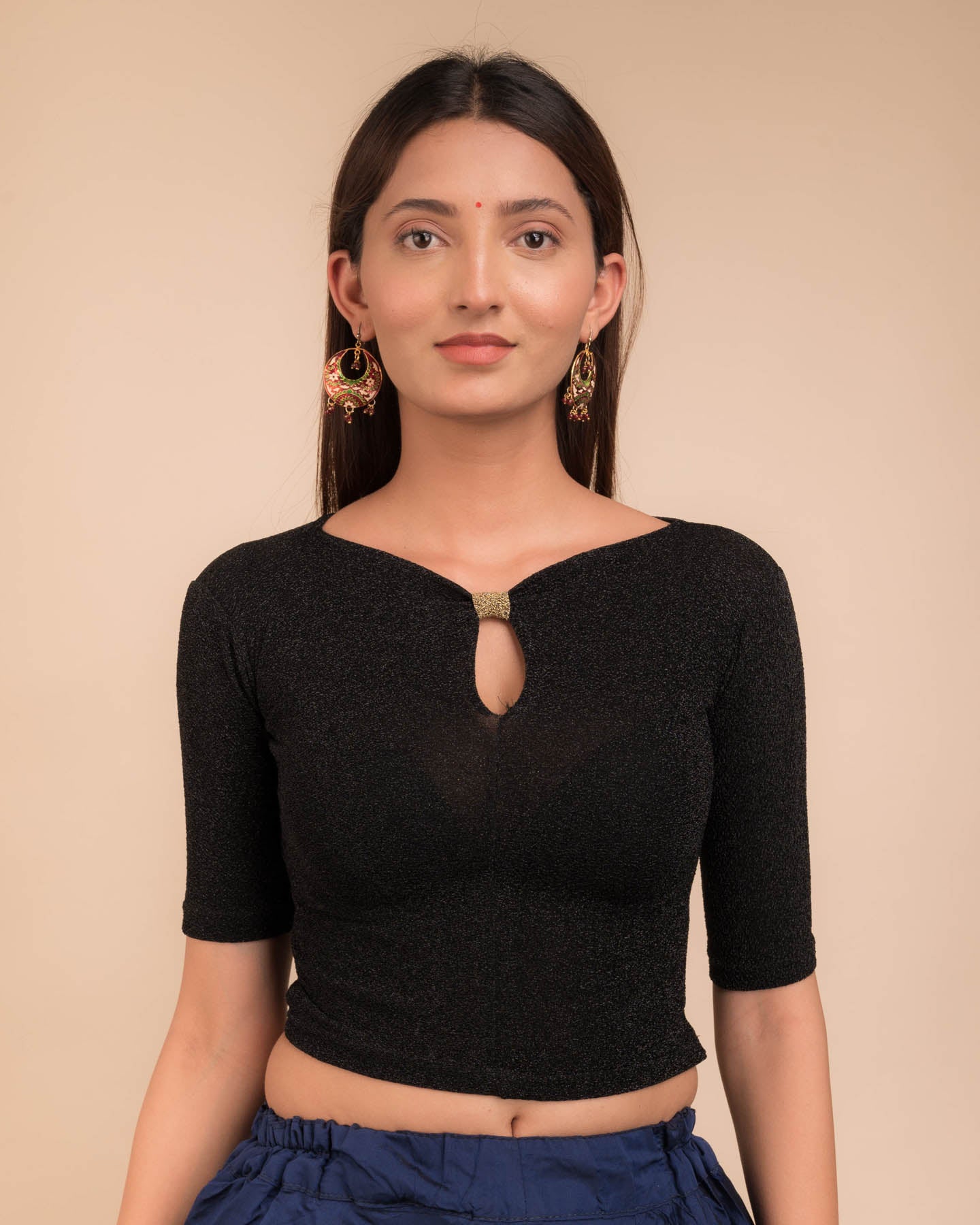 Model wearing a metallic-zari stretchable blouse with a bow-keyhole neckline and elbow sleeves