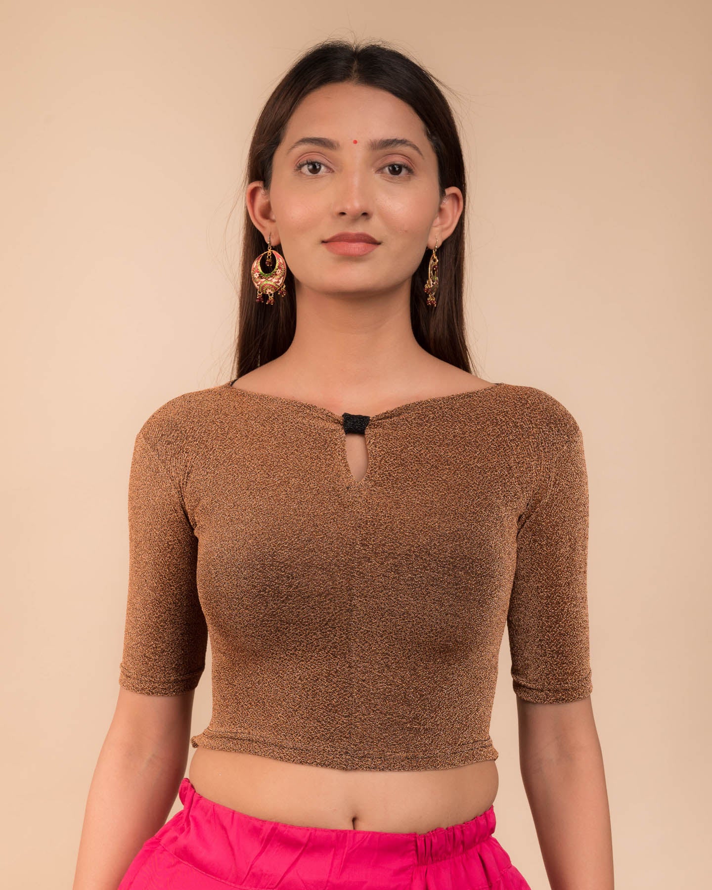 Model wearing a metallic-zari stretchable blouse with a bow-keyhole neckline and elbow sleeves