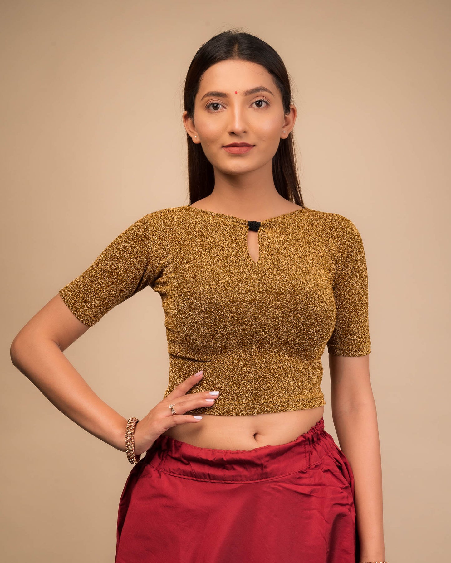 Model wearing a metallic-zari stretchable blouse with a bow-keyhole neckline and elbow sleeves