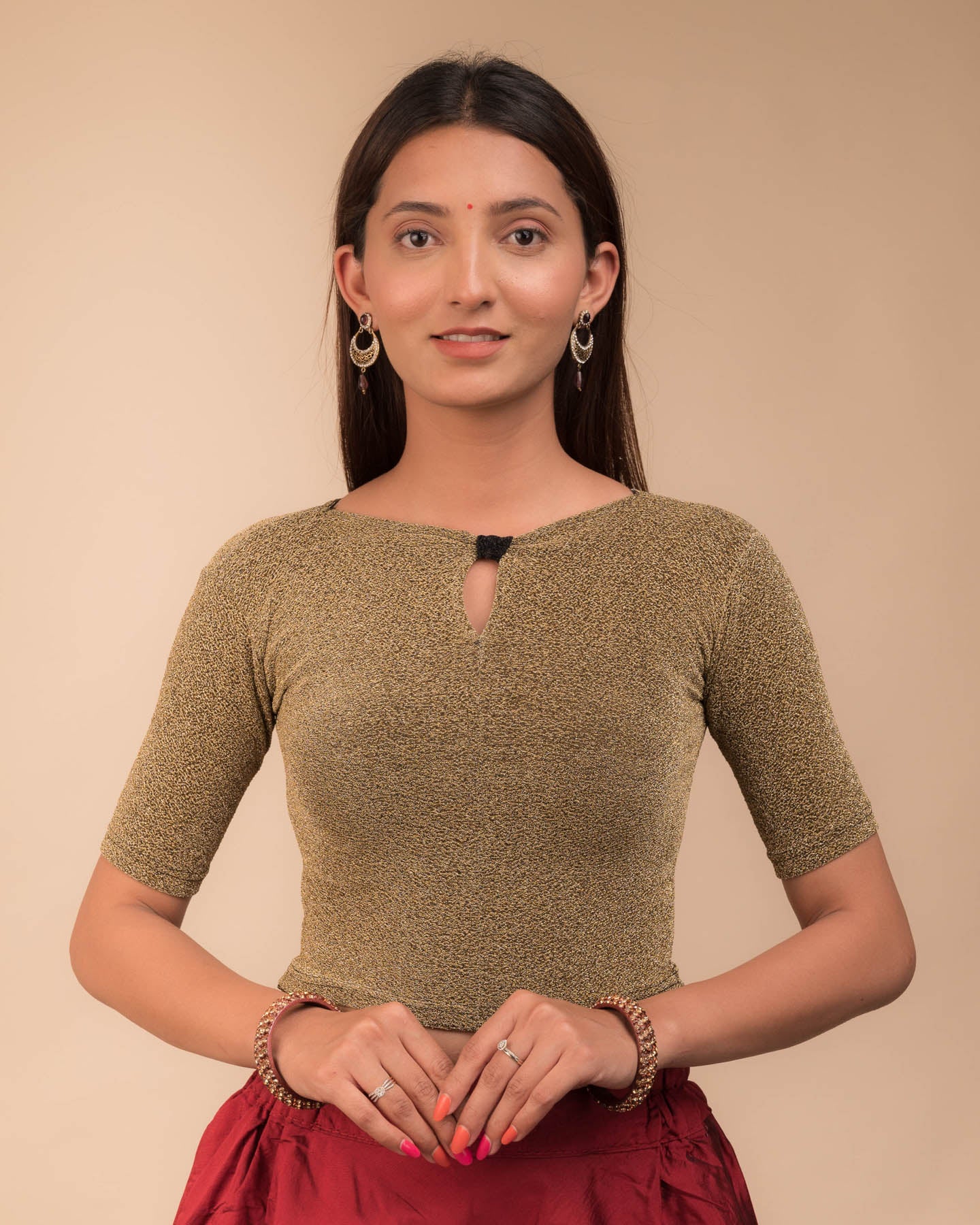 Model wearing a metallic-zari stretchable blouse with a bow-keyhole neckline and elbow sleeves