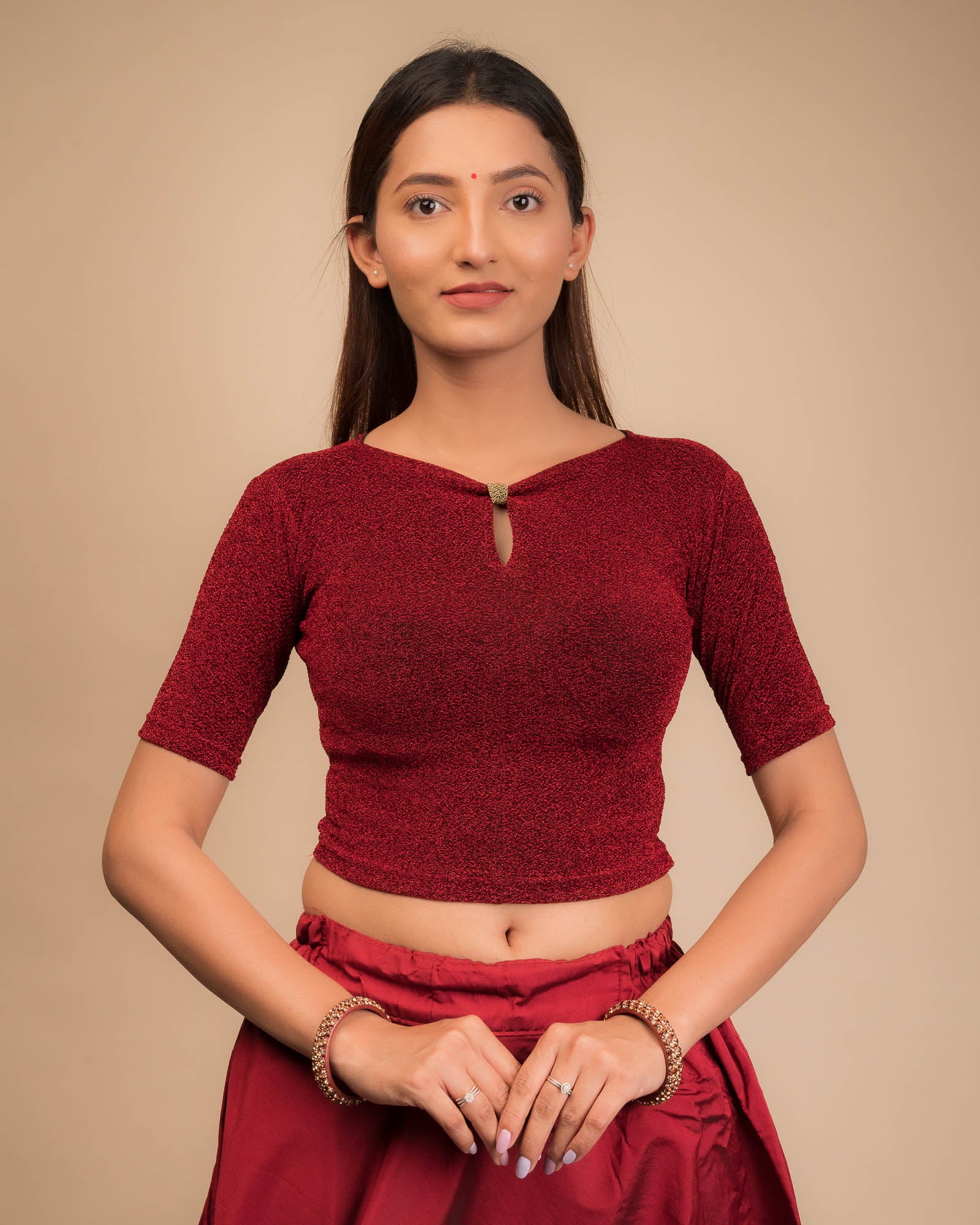 Model wearing a metallic-zari stretchable blouse with a bow-keyhole neckline and elbow sleeves