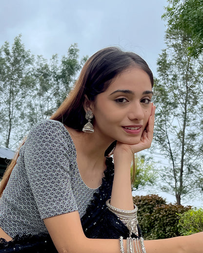 Model pairing the blouse with a luxurious saree for a festive look.