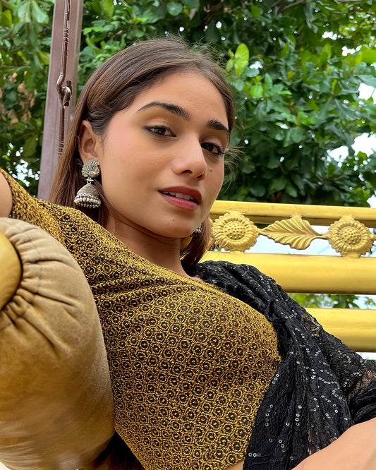 Model pairing the blouse with a luxurious saree for a festive look.
