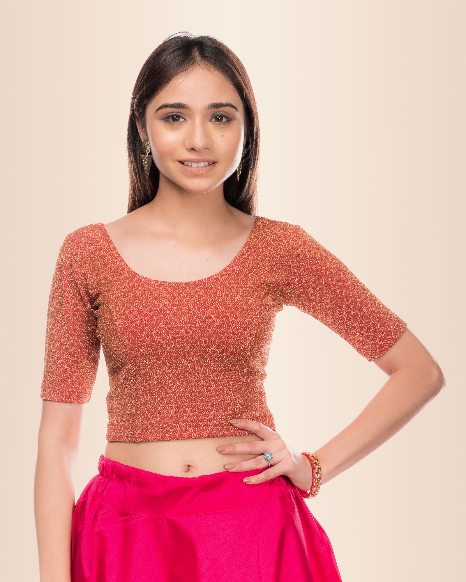 Model wearing a stretchable blouse with metallic zig-zag zari stripes, round neckline, and elbow sleeves