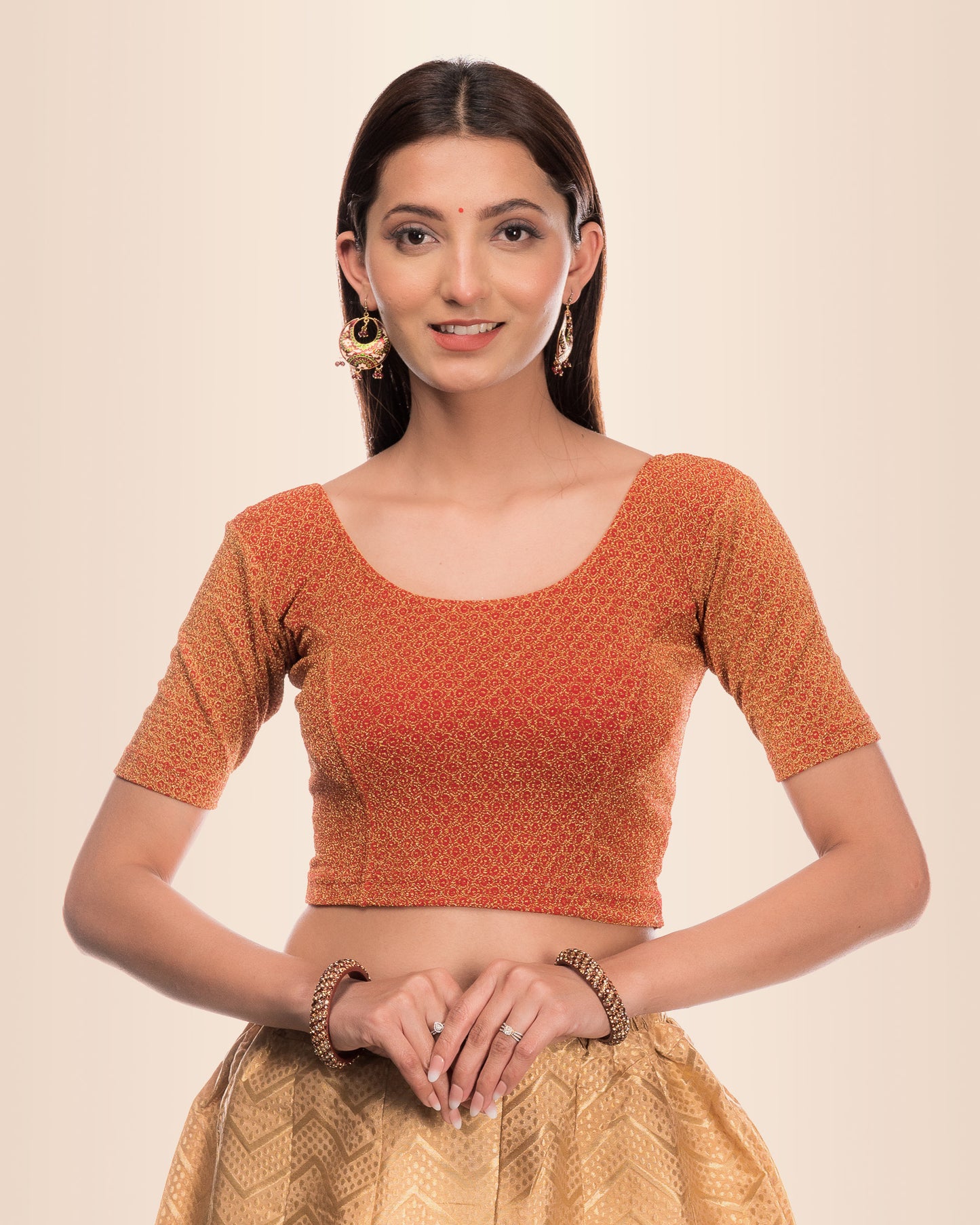Model wearing a stretchable blouse with metallic zig-zag zari stripes, round neckline, and elbow sleeves