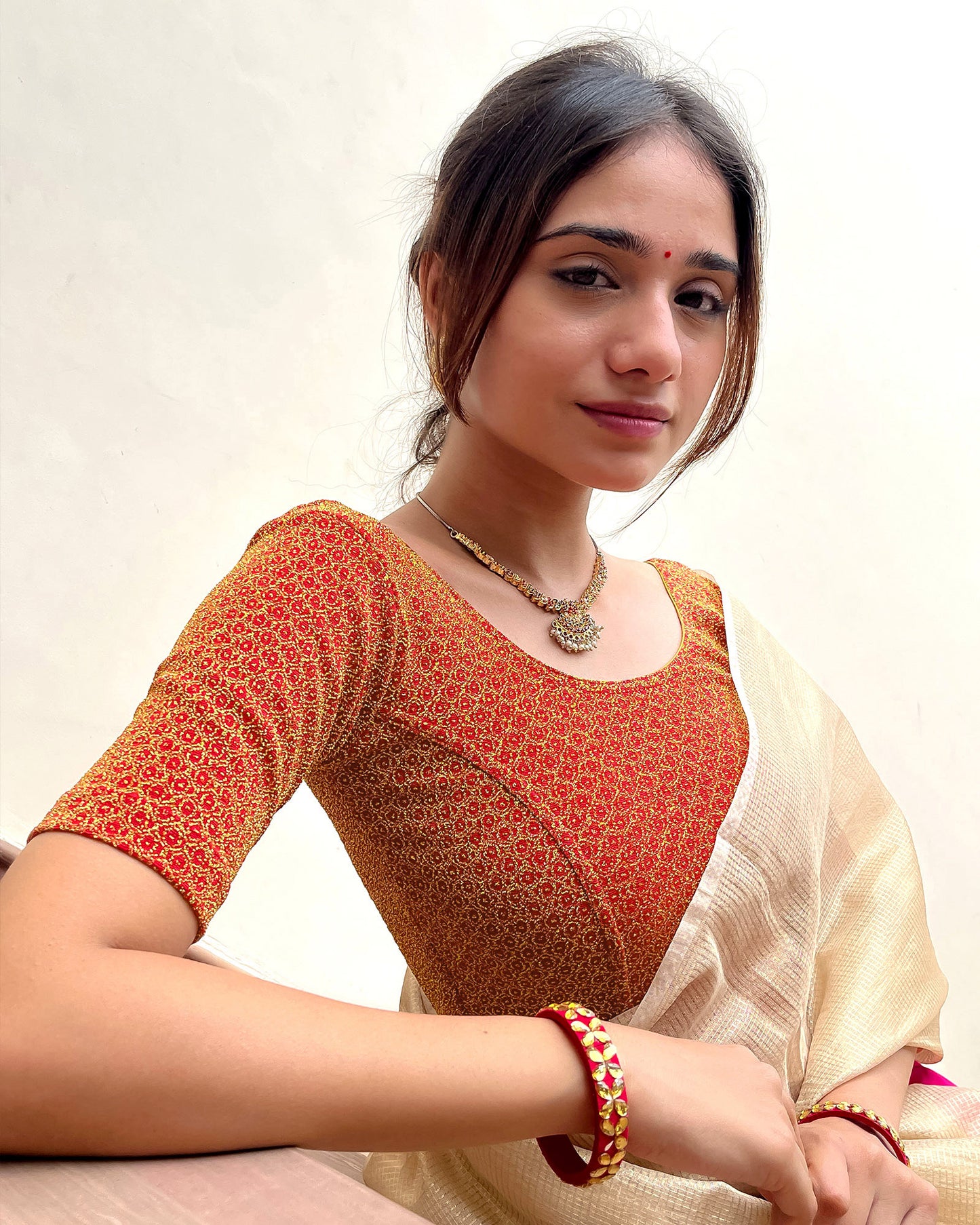 Model pairing the blouse with a luxurious saree for a festive look.