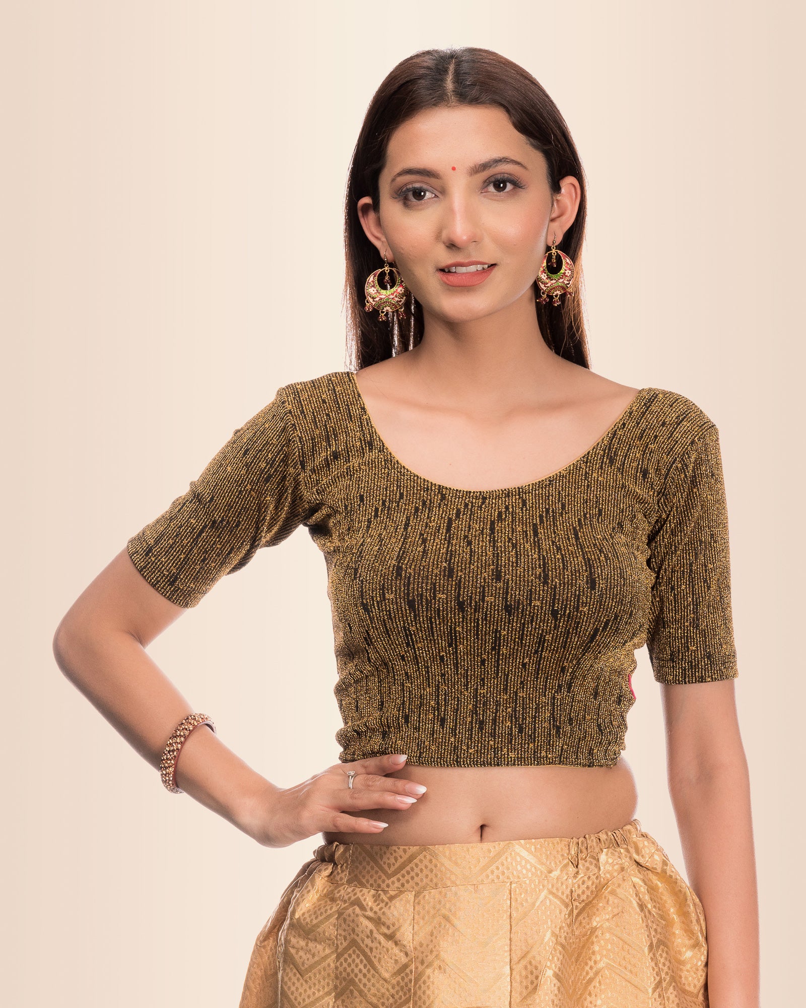 Model wearing a stretchable blouse with metallic zig-zag stripes, round neckline, and elbow sleeves.