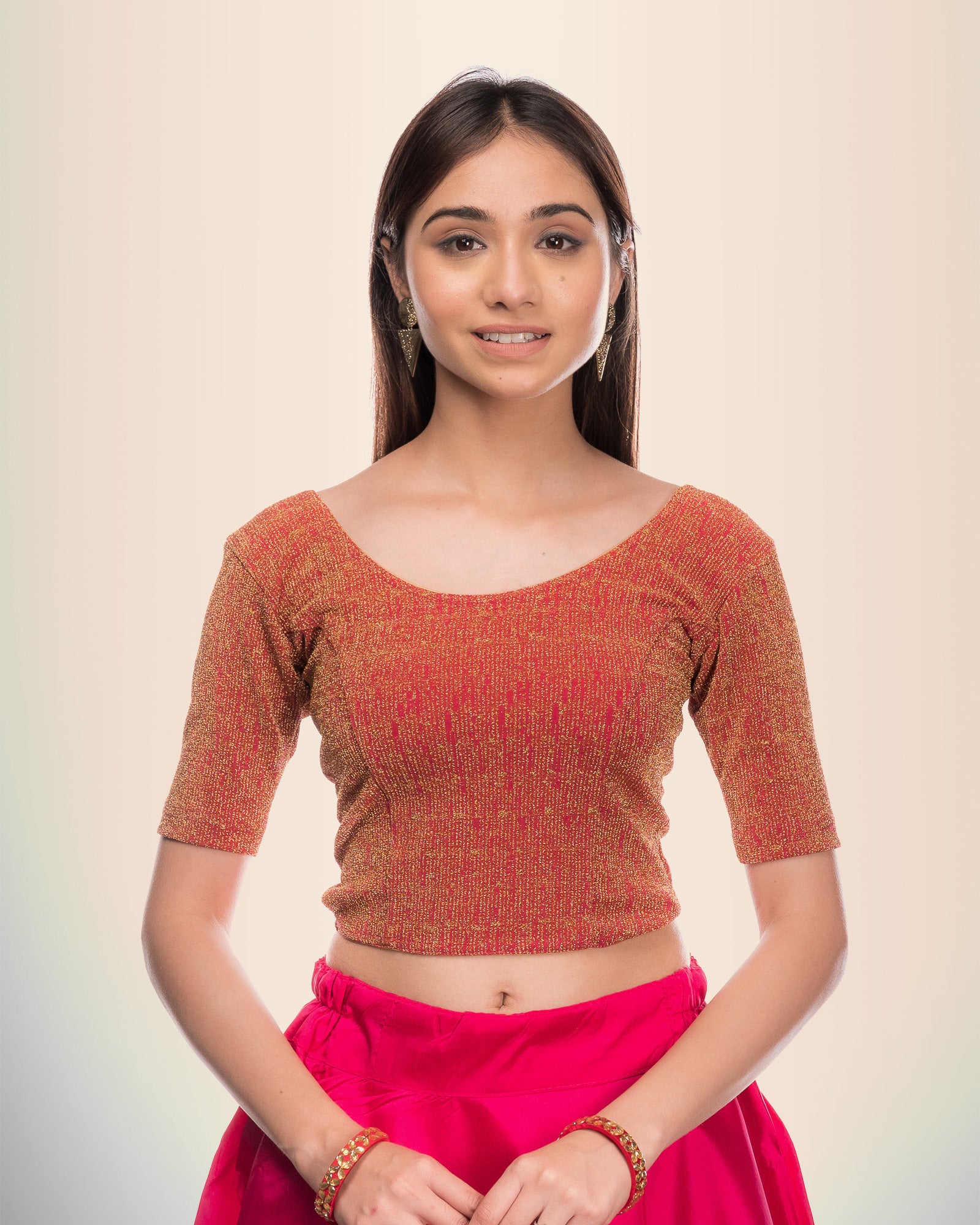 Model wearing a stretchable blouse with metallic zig-zag stripes, round neckline, and elbow sleeves.