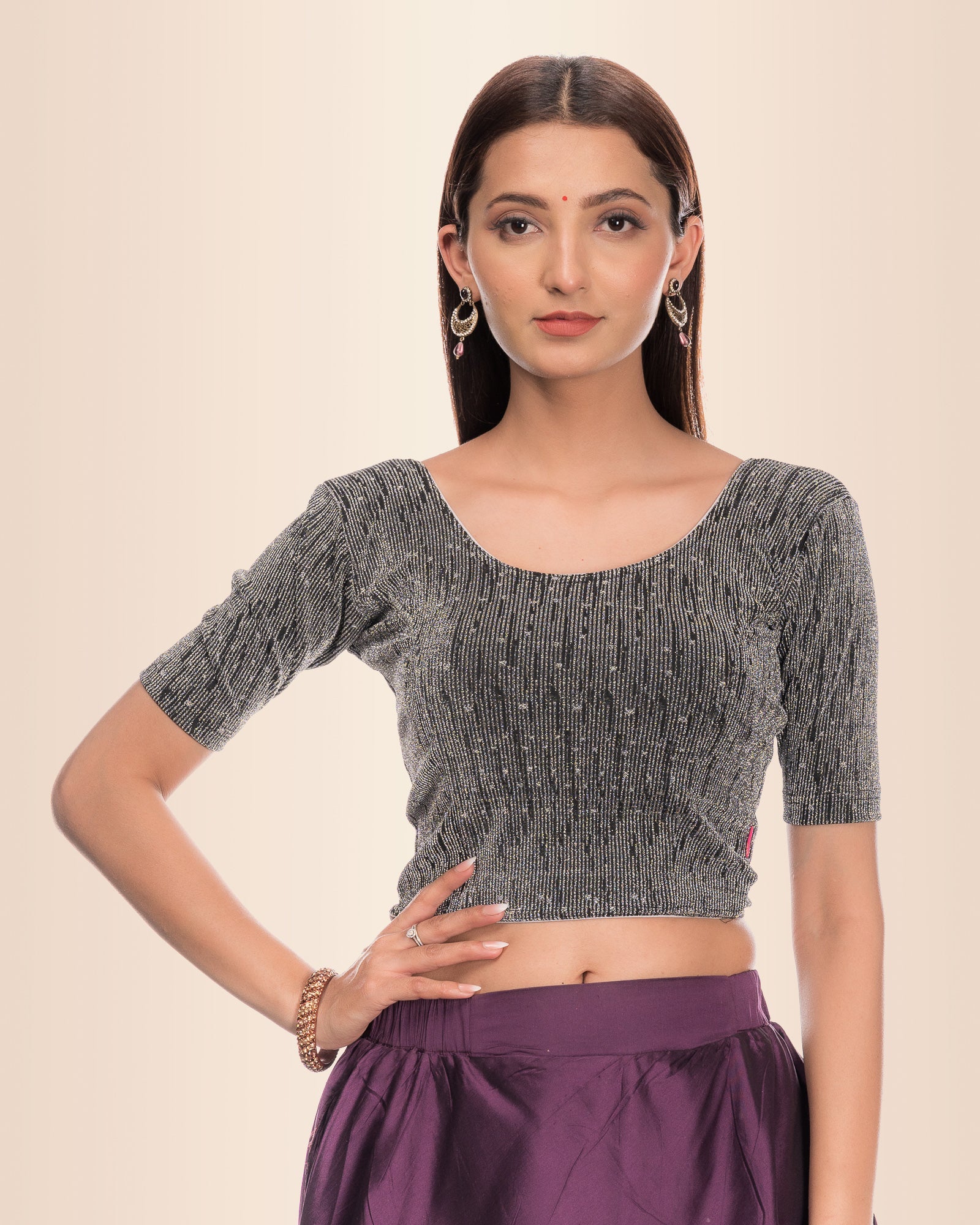 Model wearing a stretchable blouse with metallic zig-zag stripes, round neckline, and elbow sleeves.