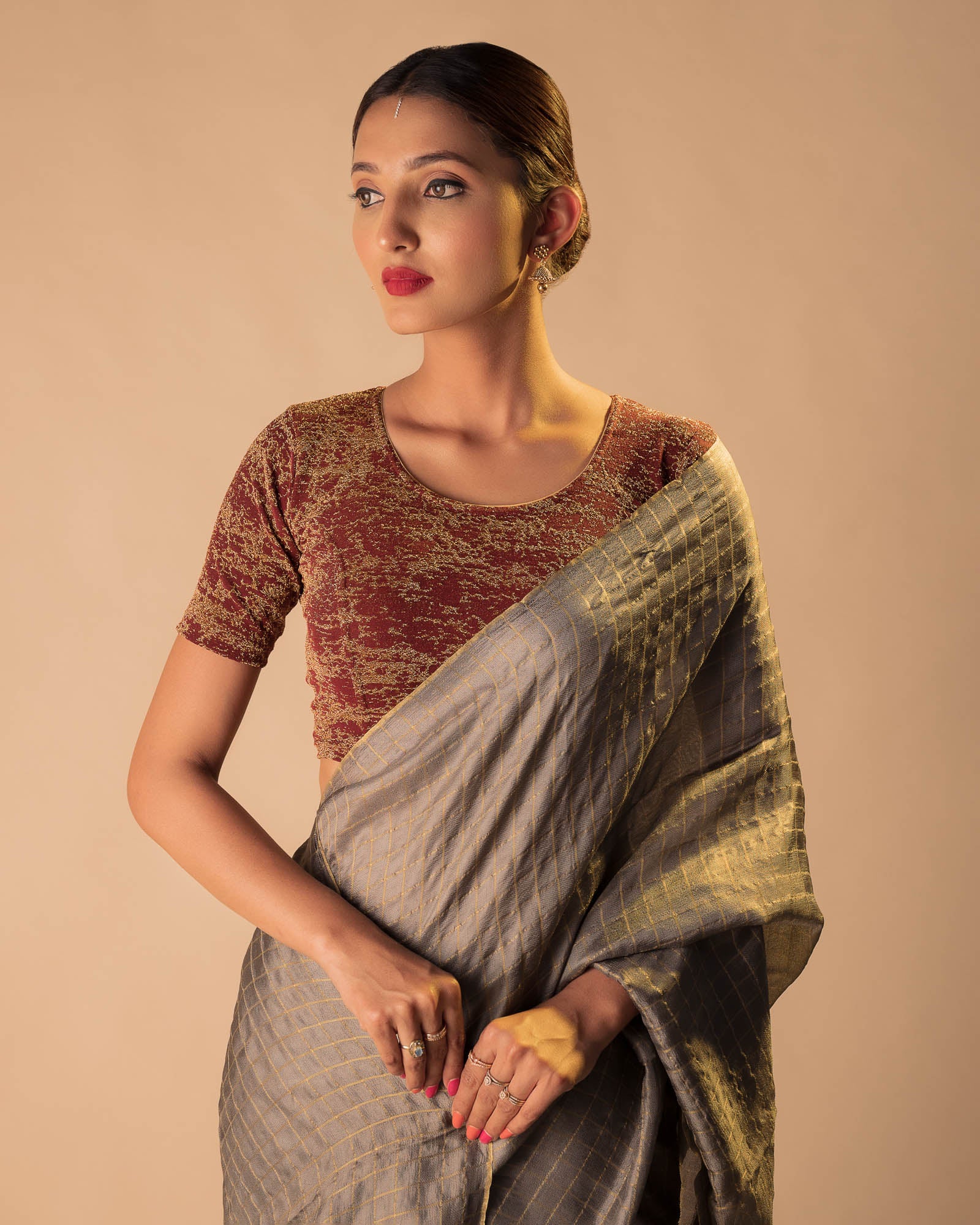 Model pairing the blouse with an ethnic saree and lehenga to highlight the latkan detailing