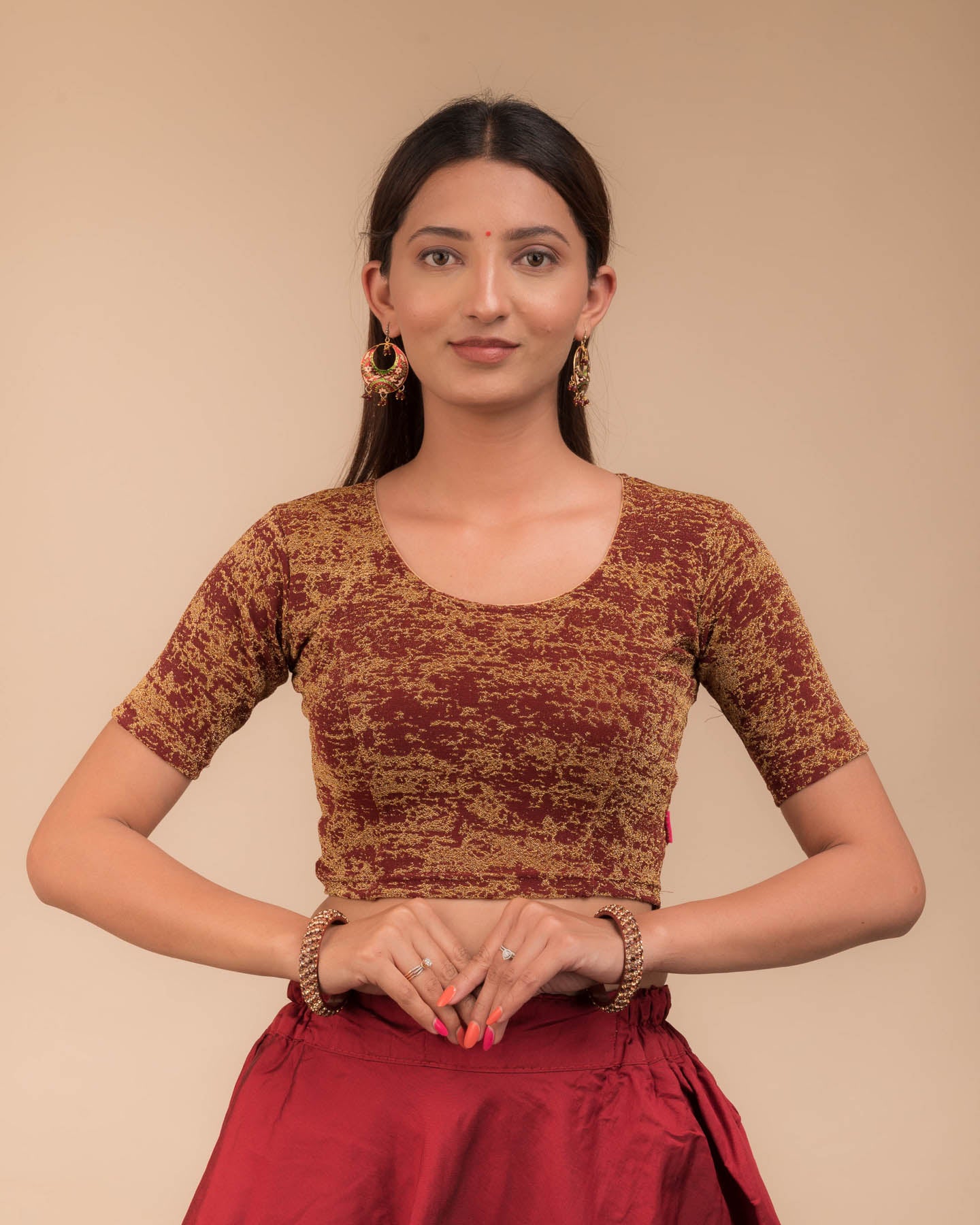 Model wearing a stretchable zari blouse with elbow sleeves and round neckline