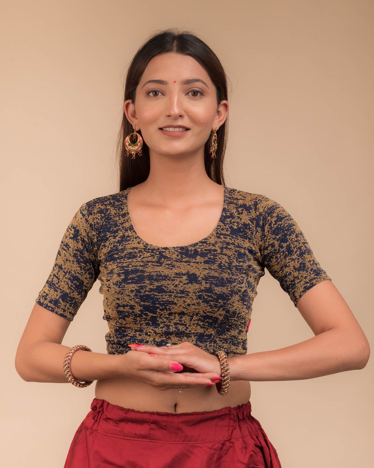 Model wearing a stretchable zari blouse with elbow sleeves and round neckline