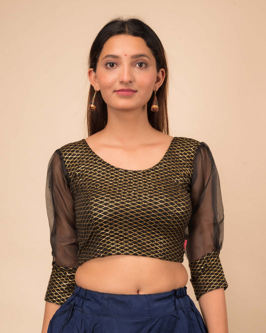 Model wearing a stretchable crushed organza blouse with long balloon sleeves, round neckline, and gold check pattern