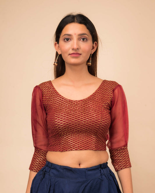 Model wearing a stretchable crushed organza blouse with long balloon sleeves, round neckline, and gold check pattern