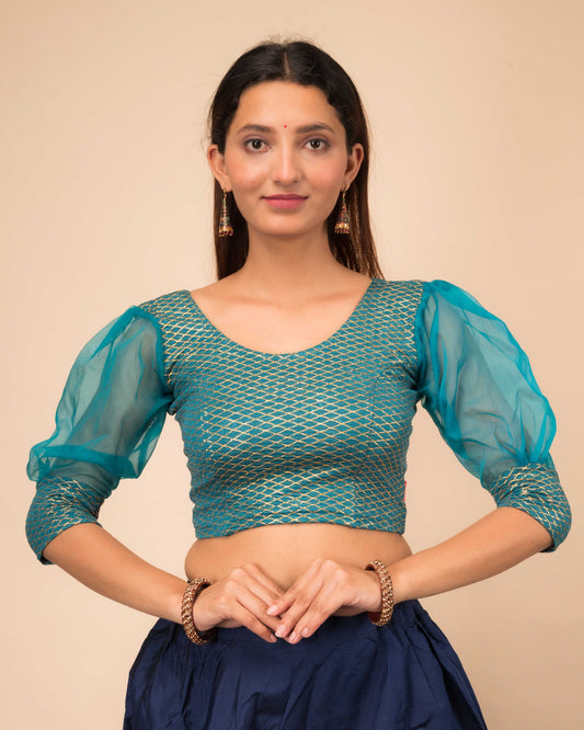 Model wearing a stretchable crushed organza blouse with long balloon sleeves, round neckline, and gold check pattern
