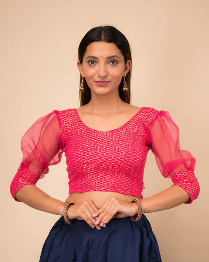 Model wearing a stretchable crushed organza blouse with long balloon sleeves, round neckline, and gold check pattern