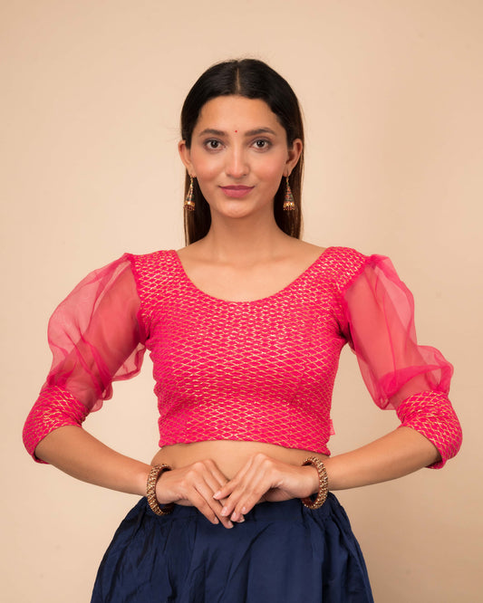 Model wearing a stretchable crushed organza blouse with long balloon sleeves, round neckline, and gold check pattern