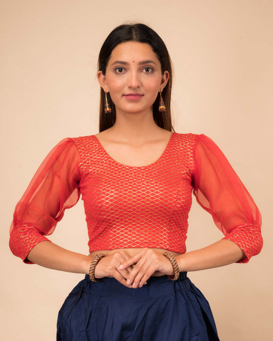 Model wearing a stretchable crushed organza blouse with long balloon sleeves, round neckline, and gold check pattern