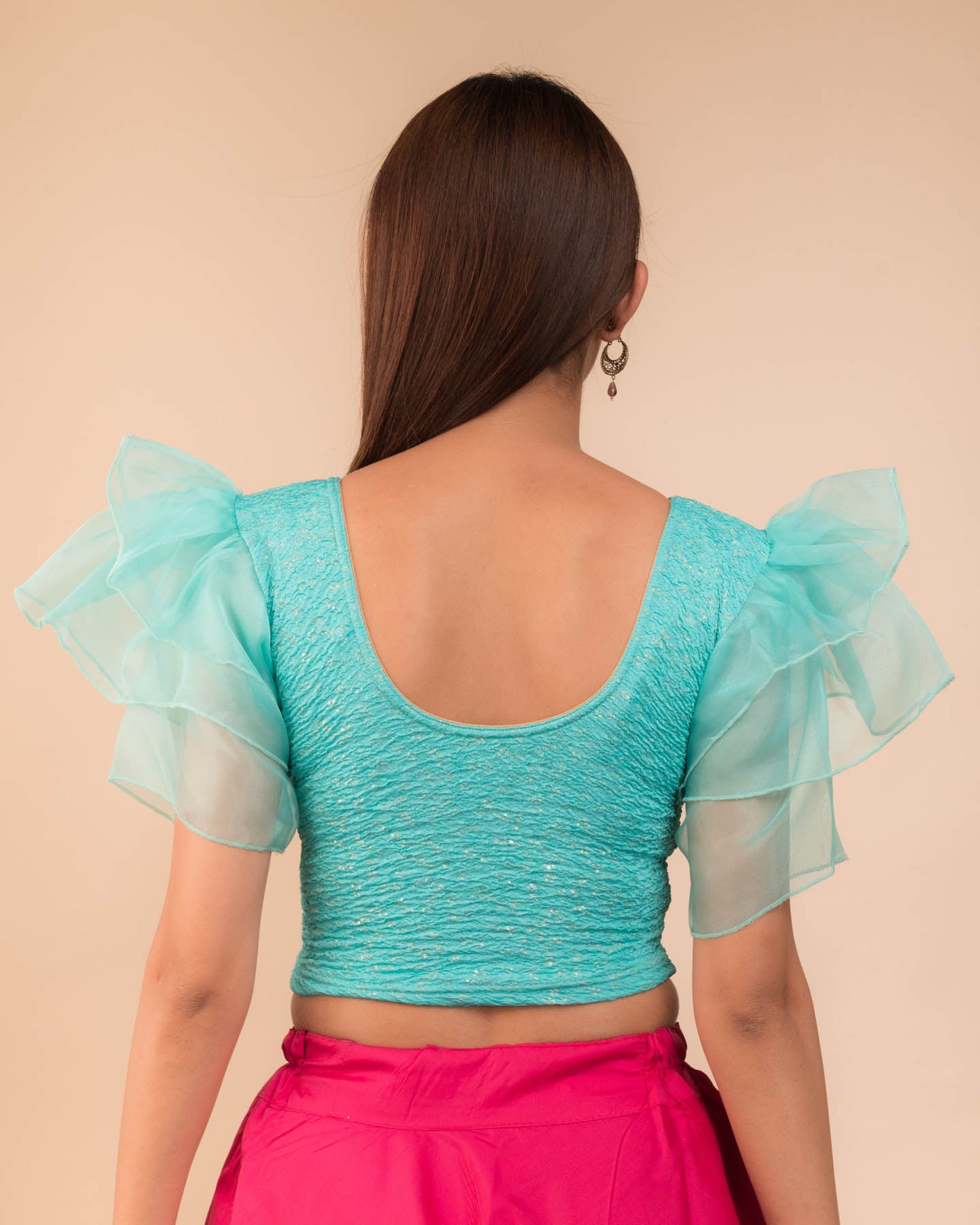 Rear view showcasing the layered ruffle sleeve design