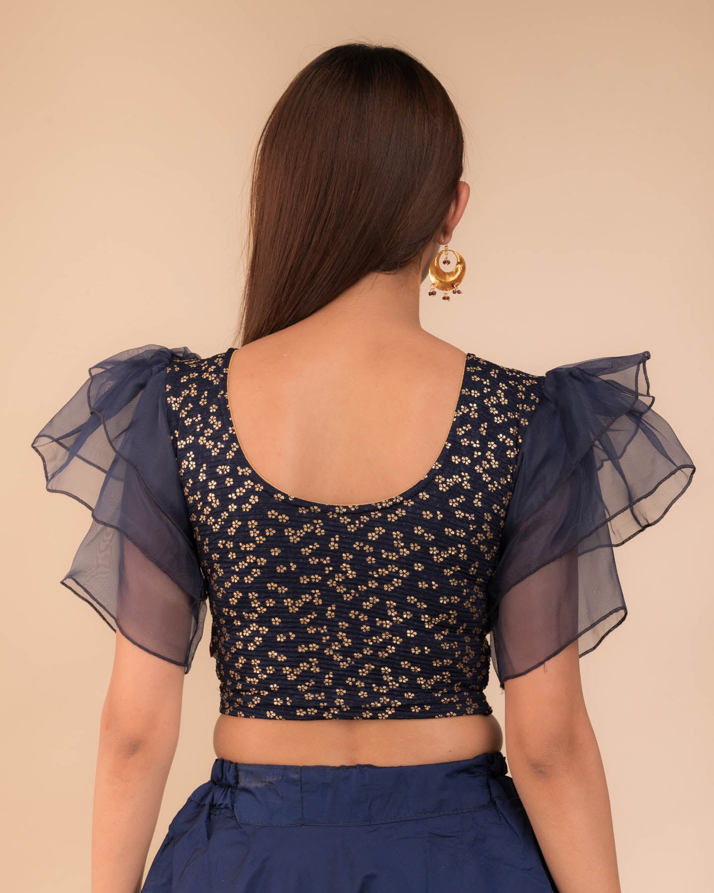 Rear view showcasing the layered ruffle sleeve design