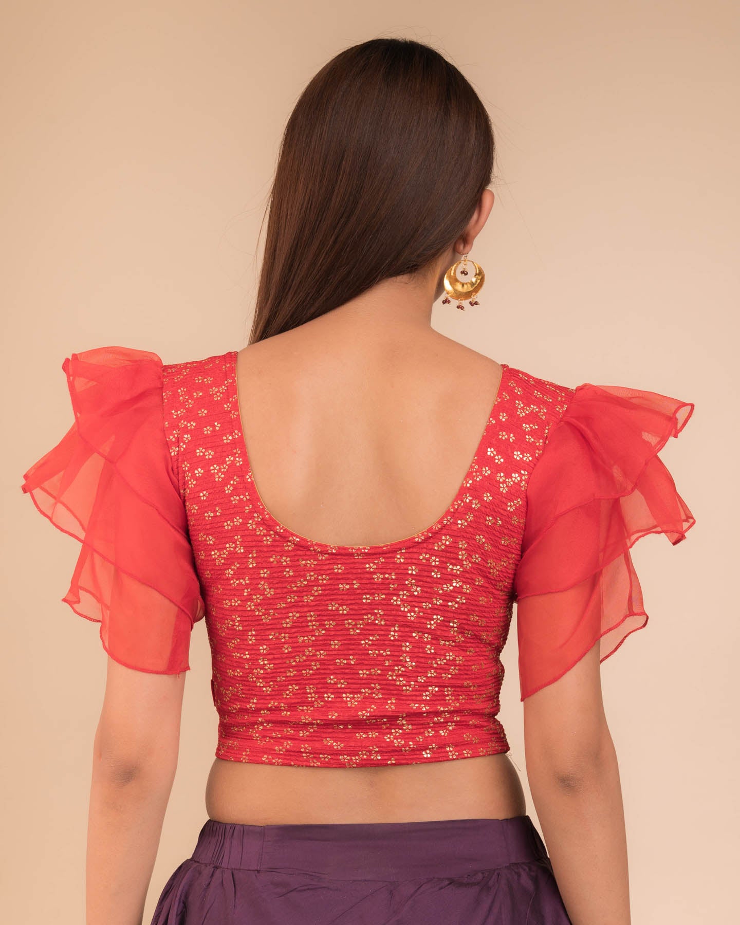 Rear view showcasing the layered ruffle sleeve design