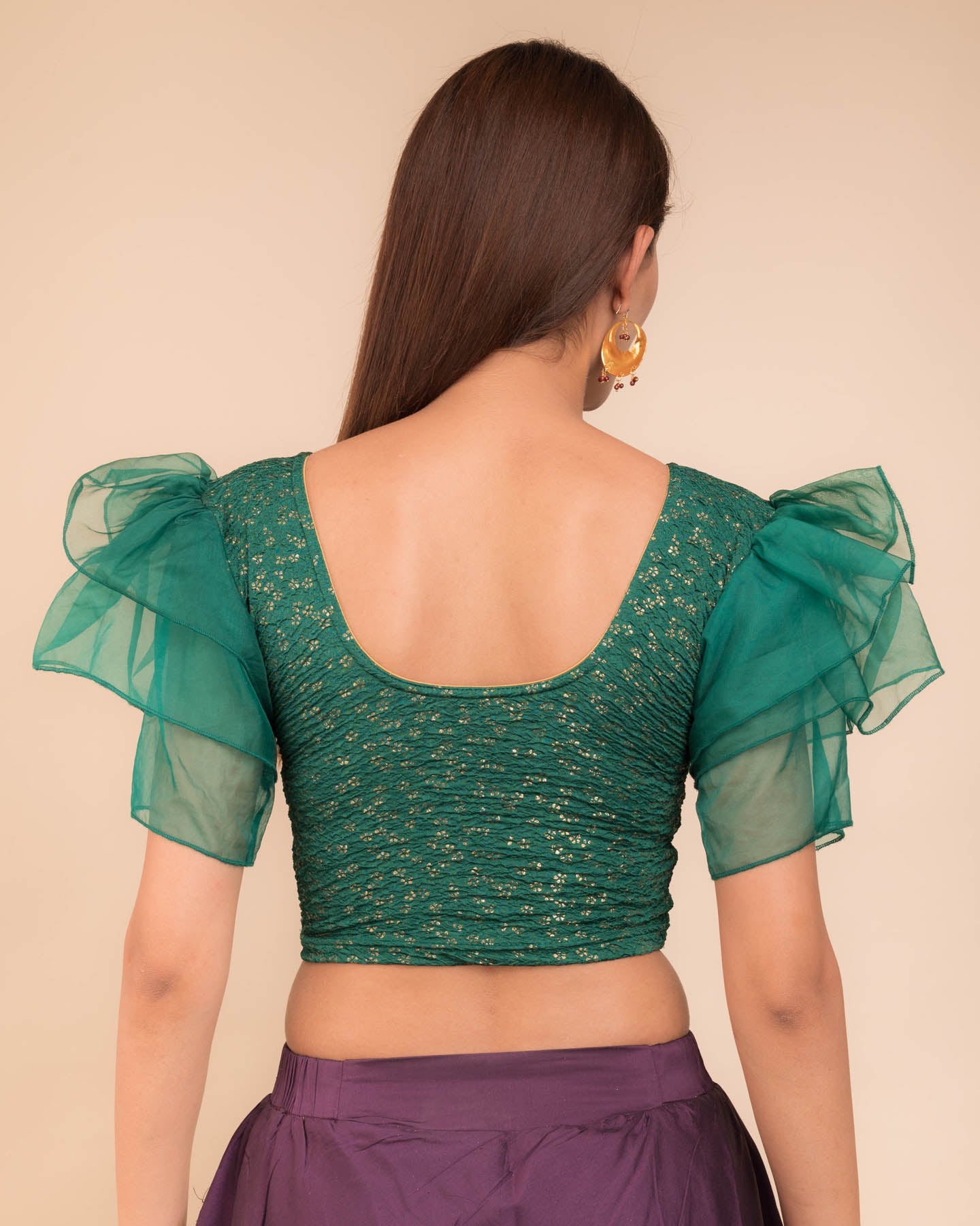 Rear view showcasing the layered ruffle sleeve design