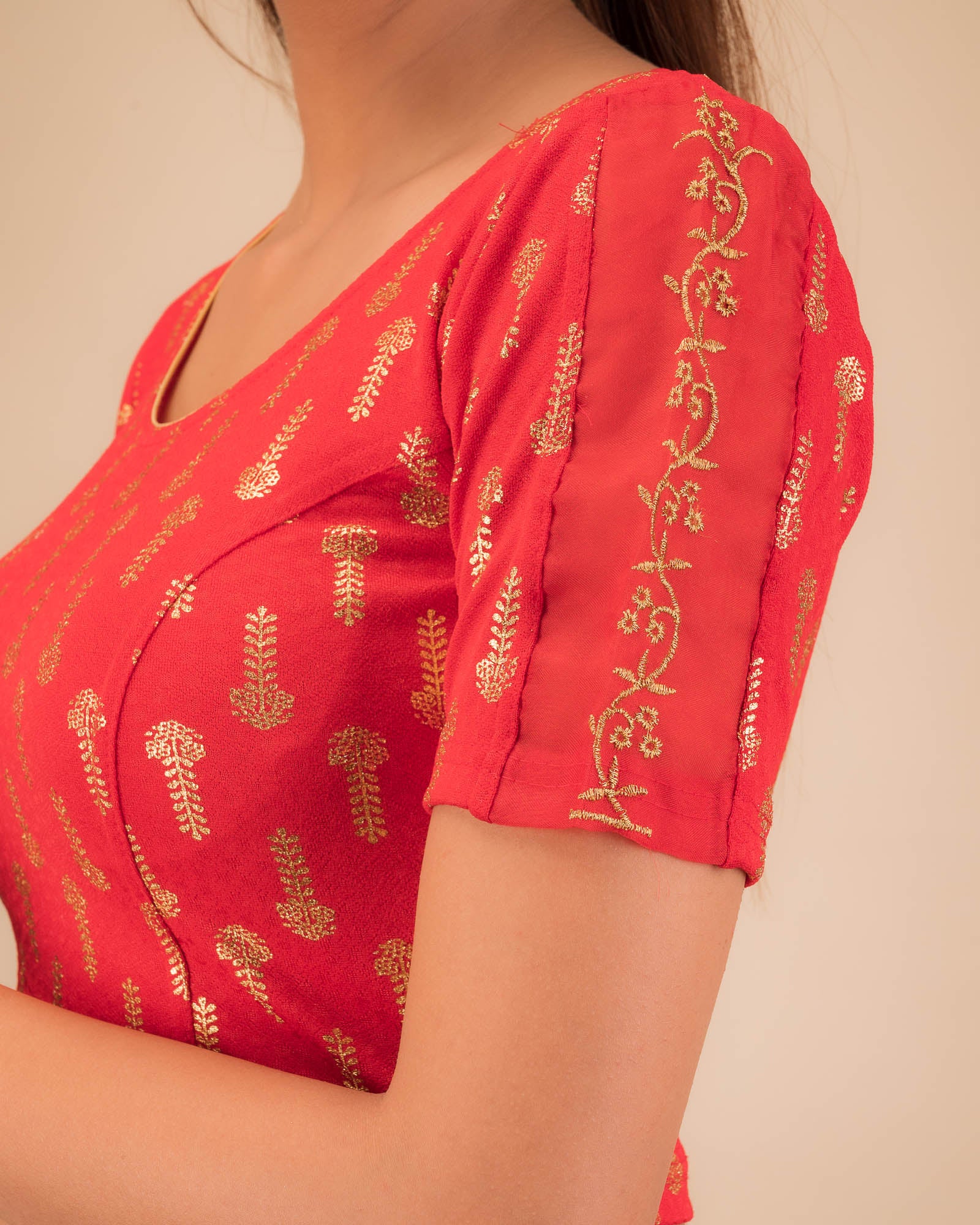 Close-up of the knit fabric with metallic print and intricate zari embroidery