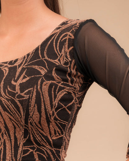 Close-up of the knit fabric with detailed zari flower appliqué