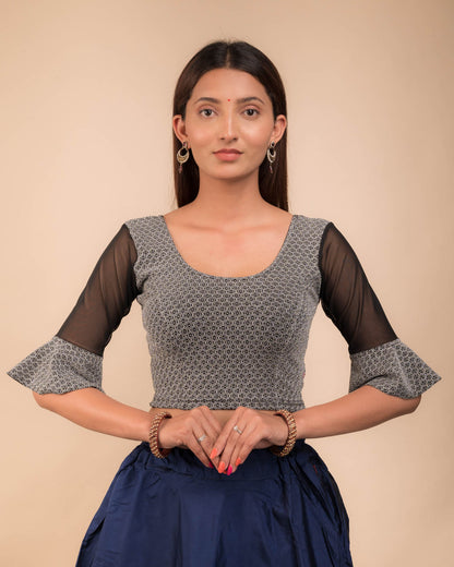 Model wearing a stretchable blouse featuring tonal zari flower appliqués, round neckline, and elbow sleeves