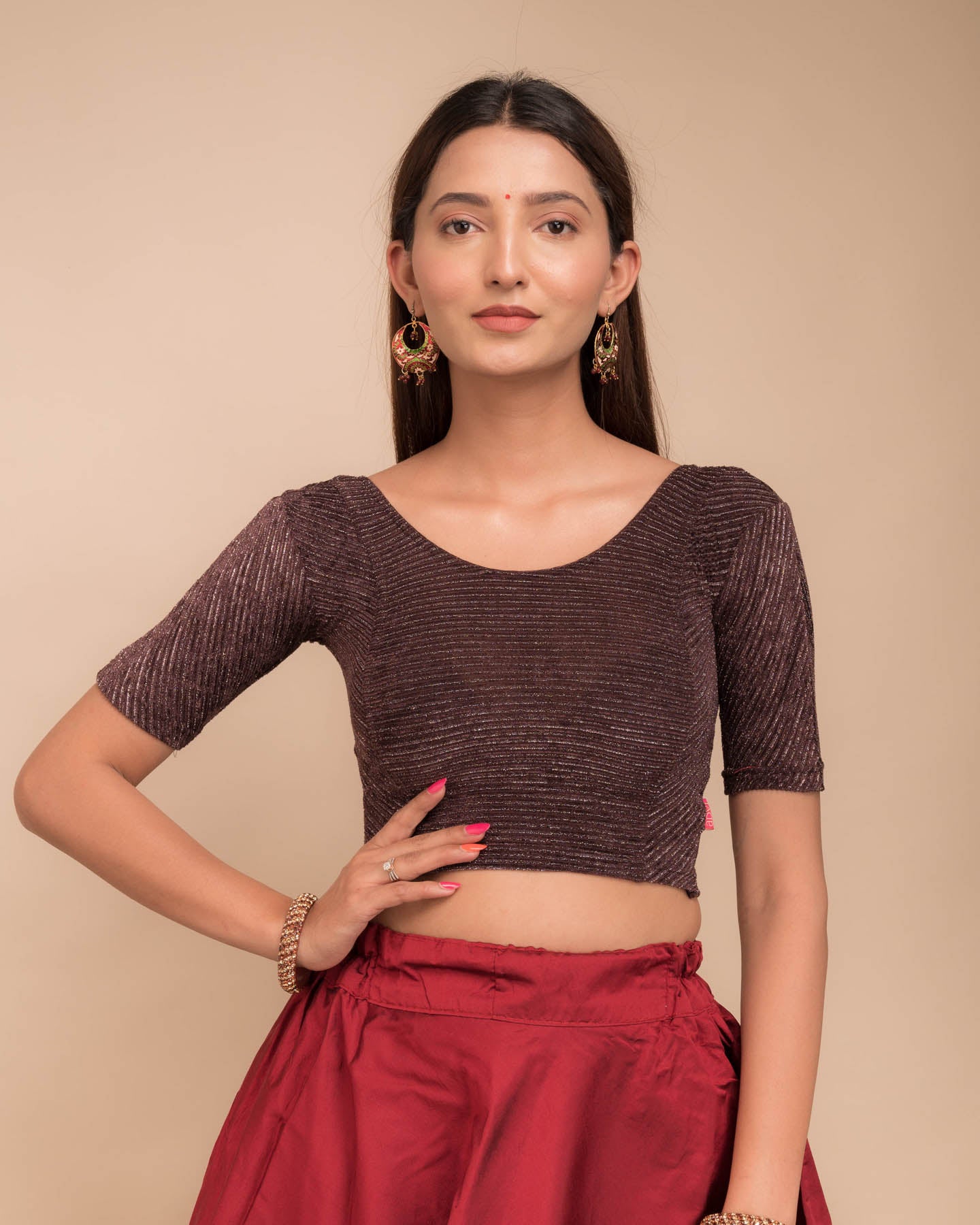 Model wearing a velvet stretchable blouse with elbow sleeves and round neckline, featuring metallic stripes.