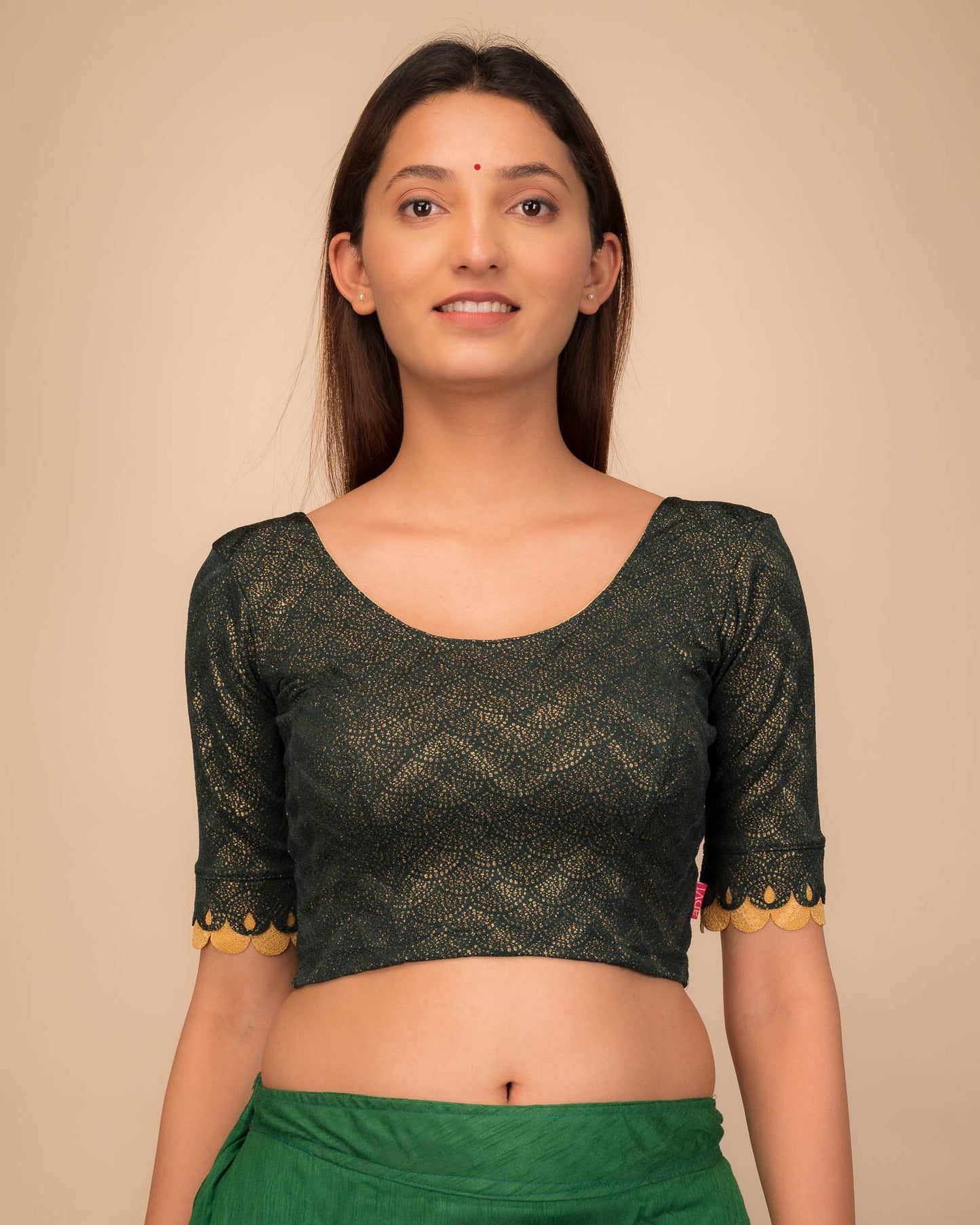 Model wearing a stretchable blouse with scallop-edged elbow sleeves and round neckline.