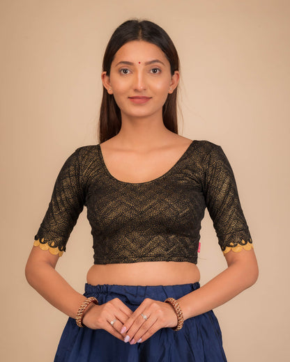 Model wearing a stretchable blouse with scallop-edged elbow sleeves and round neckline.